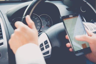 hand using phone sending a text while driving to work ,businessman ,vintage color tone
