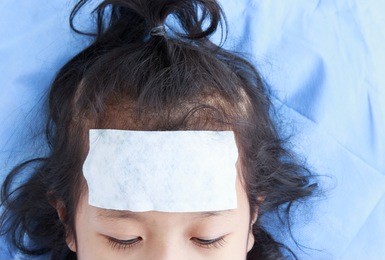 sick girl lying in bed with a cool jell in the face.medical and health care concept.