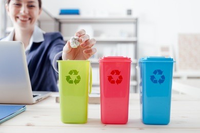 waste separate collection and recycling in the workplace, office worker sorting garbage using different trash bins