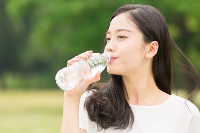 young attractive asian woman who drinks water