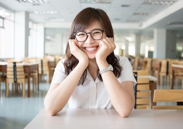 portrait of happy and smile woman asian student with uniform in classroom at library of main campus in university. happy and relax student in academic, education and school study concept