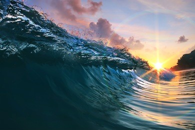 beautiful blue ocean surfing wave under sunset