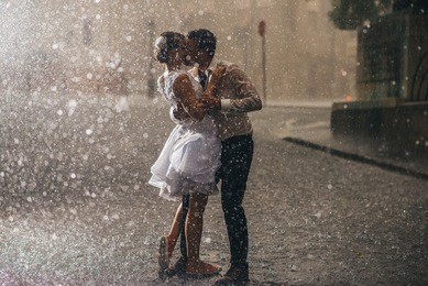 wedding couple dancing in the rain