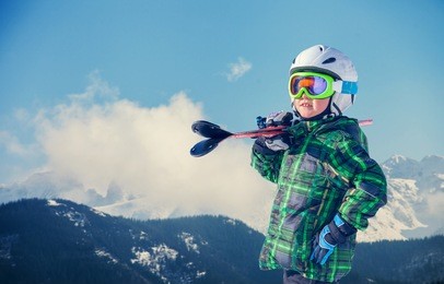 young skier portrait in snowy mountain