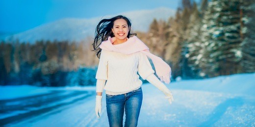 woman portrait outdoors on snowy white winter day.