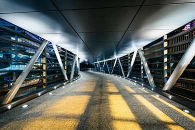covered pedestrian bridge at night, in hong kong, hong kong.