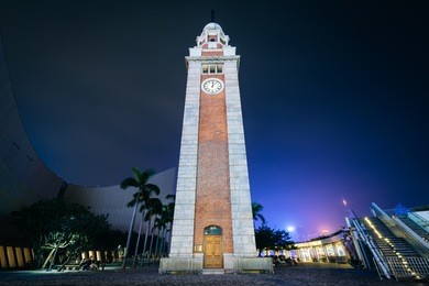 the tsim sha tsui clock tower at night, in kowloon, hong kong.