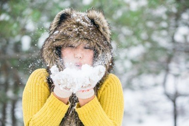 asian girl in a fur hat from the hide of a wolf.