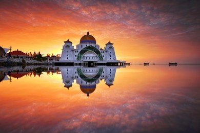 clear reflections during sunrise at straits mosque, malacca. nature composition.