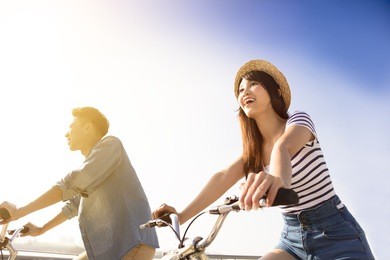 happy young couple going for  bicycle ride on a sunny day