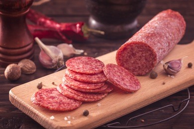 sliced salami on cutting board.toned
