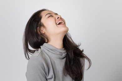 young happy asia woman is laughing.