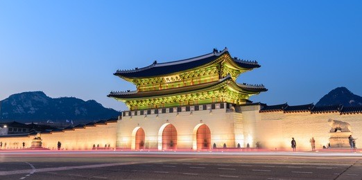 gyeongbokgung palace at night in south korea, with the name of the palace 'gyeongbokgung' on a sign