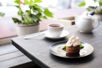 breakfast time . tea and cake with cream, garnished with mint leaves