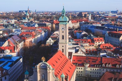 beautiful super wide-angle sunny aerial view of munich, bayern, bavaria, germany with skyline and scenery beyond the city, seen from the observation deck of st. peter church 