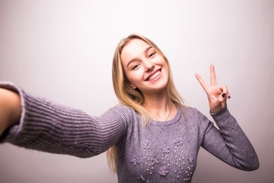 selfie time. joyful young women making selfie by her smart phone 