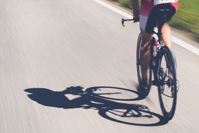 speedy shadow - a cyclist at top speed on the triathlon race.