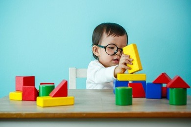 kid toddler playing wooden toys at home or nursery, baby healthy and preschool concept