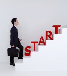 business man start stepping up on stairs to success of bussiness