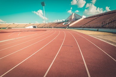 red running track in stadium. running track on blue sky. field run in stadium background.