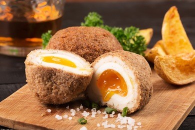traditional scotch eggs on a wooden plate