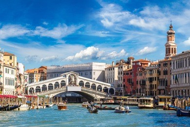 gondola at the rialto bridge in venice, in a beautiful summer day in italy 