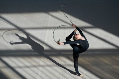 girl making a balance rope. rhythmic gymnastics.