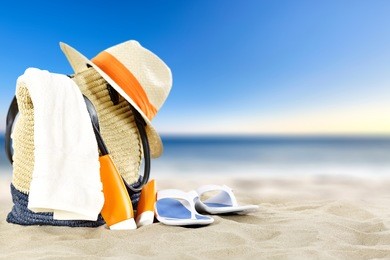 summer landscape of beach and blue sky with hat and bag and shoes 