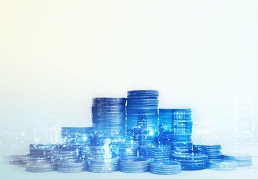 double exposure of city and rows of coins for finance and banking concept
