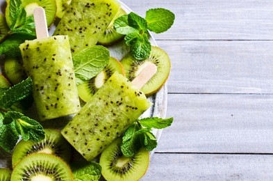 homemade fruit popsicle with kiwi and mint. selective focus.