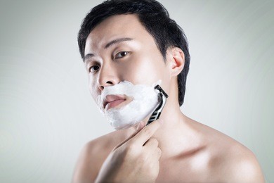 asian man is shaving 