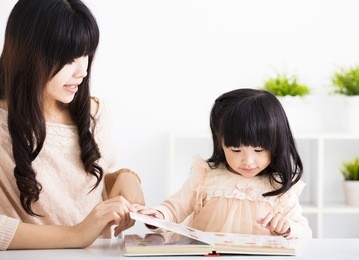 mother  helping child daughter to reading
