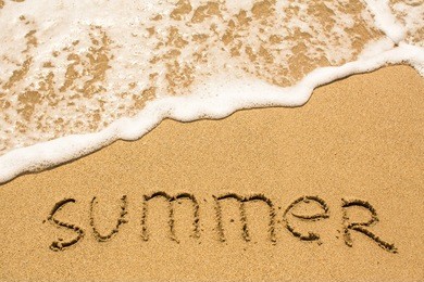 summer inscription on the sea beach sand, soft wave.