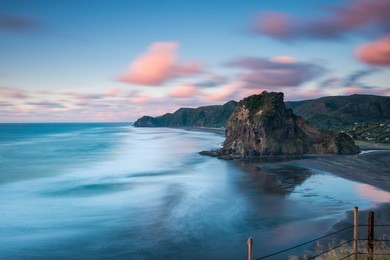 lion rock, piha beach at sunset | auckland, new zealand