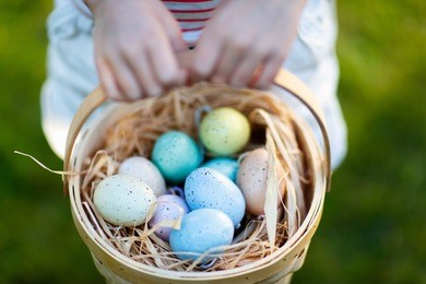 close up of colorful easter eggs in a basket