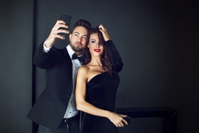 fashionable rich celebrity couple taking selfie indoor