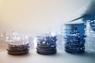 double exposure of city and rows of coins for finance and banking concept