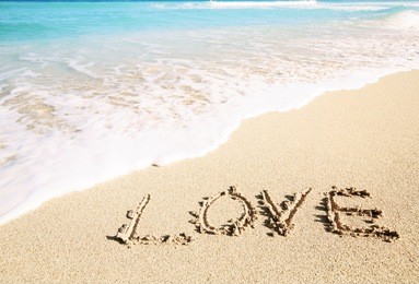 love inscribed in the sand of a tropical beach