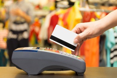 hand swiping credit card in store