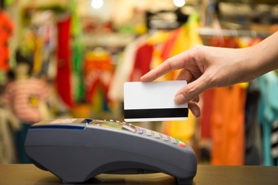 hand swiping credit card in store