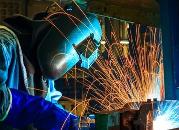 welder man welding, spark, light and hot. metal, iron work, and work. mask and gloves for protection. industry, industrial.
