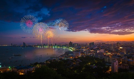 multicolor fireworks night scene, blurred photo pattaya cityscape sea beach view, thailand