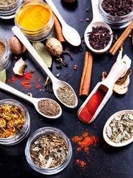 spices on black background in special jars. food