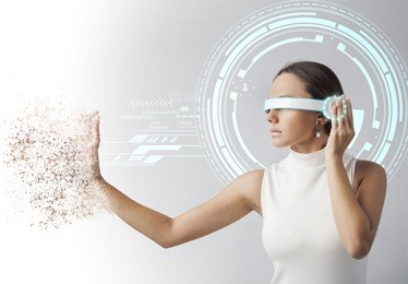 young woman looking at virtual graphics in futuristic background