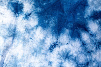 the fabric is indigo dye,local fabric,indigo tie dye pattern on cotton fabric abstract background.