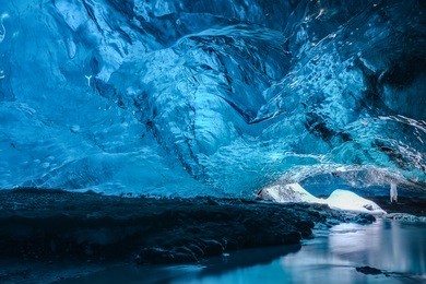 inside an ice cave in vatnajokull, iceland. the ice is thousands of years old and so packed it is harder than steel and crystal clear.