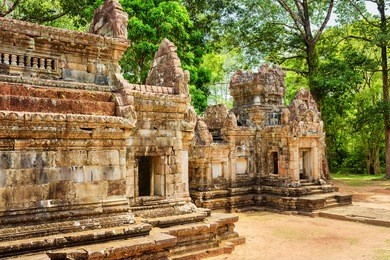 side view of ancient thommanon temple in amazing angkor, siem reap, cambodia. mysterious thommanon nestled among rainforest. enigmatic angkor is a popular tourist attraction.
