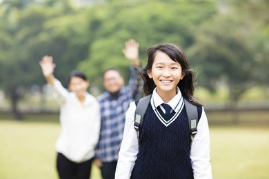 cute young student girl with parent in school