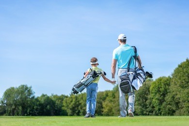father and son on golf course