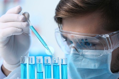 man in laboratory checking test tubes